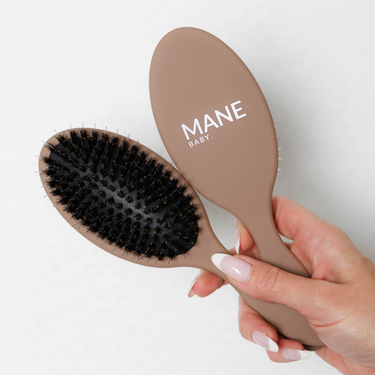 The Mane Baby Hair Extension Original Boar Bristle Brush is the ultimate hair brush for both your luxury hair extensions and natural hair. Designed with a premium blend of boar bristles and nylon bristles, this brush effortlessly detangles while nourishing your hair by distributing natural oils from root to tip, leaving your locks silky and smooth.
Perfectly suited for maintaining the high-quality feel and longevity of your Mane Baby hybrid flat weft extensions, this brush is gentle yet effective, ensuring